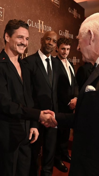 Kind Charles shaking hands with Pedro Pascal at the Global Premiere of Gladiator II, with Denzel Washington and Paul Mescal in the background